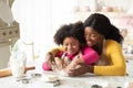 Happy Family In Kitchen. Black Mother And Little Ddaughter Preparing Dough Together Royalty Free Stock Photo