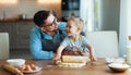 Happy family in kitchen. father and child baking cookies