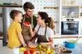 Happy family in the kitchen having fun and cooking together. Healthy food at home. Royalty Free Stock Photo