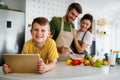 Happy family in the kitchen having fun and cooking together. Healthy food at home. Royalty Free Stock Photo