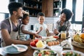 Happy family in the kitchen having fun and cooking together. Healthy food at home. Royalty Free Stock Photo