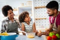 Happy family in the kitchen having fun and cooking together. Healthy food at home. Royalty Free Stock Photo