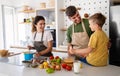 Happy family in the kitchen having fun and cooking together. Healthy food at home. Royalty Free Stock Photo