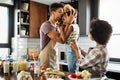 Happy family in the kitchen having fun and cooking together. Healthy food at home. Royalty Free Stock Photo