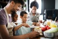 Happy family in the kitchen having fun and cooking together. Healthy food at home. Royalty Free Stock Photo