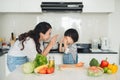 Happy family in the kitchen. Mother and child daughter are preparing the vegetables and fruit. Royalty Free Stock Photo