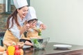 Happy family in the kitchen. mother and child daughter preparing the dough, salad Royalty Free Stock Photo