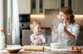 Happy family in kitchen. mother and child preparing dough, bake cookies Royalty Free Stock Photo