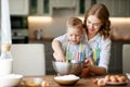 Happy family in kitchen. mother and child preparing dough, bake cookies Royalty Free Stock Photo