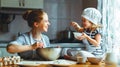 Happy family in kitchen. mother and child preparing dough, bake Royalty Free Stock Photo