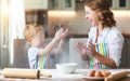 Happy family in kitchen. mother and child preparing dough, bake cookies Royalty Free Stock Photo