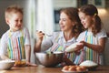 Happy family in kitchen. mother and children preparing dough, bake cookies Royalty Free Stock Photo