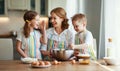 Happy family in kitchen. mother and children preparing dough, bake cookies Royalty Free Stock Photo