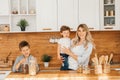 Happy family in the kitchen. mother and children preparing the dough, bake cookies Royalty Free Stock Photo