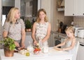 Happy Family in the Kitchen. Mother and Daughters Having Fun Baking or Making Pizza at Home. Domestic Food Concept Royalty Free Stock Photo