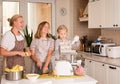 Happy Family in the Kitchen. Mother and Daughters Having Fun Cooking at Home. Domestic Food Concept