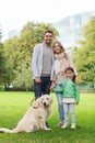 Happy family with labrador retriever dog in park Royalty Free Stock Photo