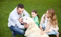 Happy family with labrador retriever dog in park Royalty Free Stock Photo