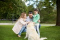 Happy family with labrador retriever dog in park Royalty Free Stock Photo