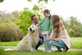 Happy family with labrador retriever dog in park Royalty Free Stock Photo