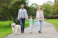 Happy family with labrador retriever dog in park Royalty Free Stock Photo