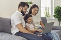 Happy family with laptop doing online shopping in the online store remotely at home. Royalty Free Stock Photo