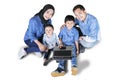 Happy family with laptop smiling at camera Royalty Free Stock Photo