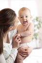 Happy family laughing faces, mother holding cute child baby boy. Young woman and her small son have a fun pastime. Royalty Free Stock Photo