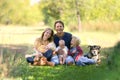 Happy Family Laughing Together with Dog Outside Royalty Free Stock Photo