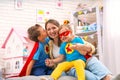 Happy family. A laughing young woman plays superhero games with her children Royalty Free Stock Photo