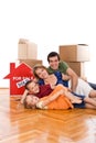 Happy family laying on the floor of their new home Royalty Free Stock Photo