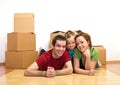 Happy family laying on the floor in their new home