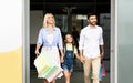 Happy Family Leaving Shopping Mall Carrying Shopper Bags Royalty Free Stock Photo