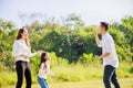 Happy family life concept. Asian parents Father, Mother and the little girl enjoying and fun during playing soap bubbles. family Royalty Free Stock Photo