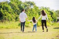 Happy family life concept. Asian parents Father, Mother and the little girl walking and have fun and enjoyed ourselves together Royalty Free Stock Photo