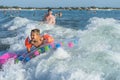 Happy family lifestyle. ÃÂ¡hildren jumping and splashing with fun in breaking waves Royalty Free Stock Photo