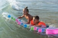 Happy family lifestyle. ÃÂ¡hildren jumping and splashing with fun in breaking waves. Brother and sister Royalty Free Stock Photo