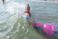 Happy family lifestyle. ÃÂ¡hildren jumping and splashing with fun in breaking waves. Brother and sister Royalty Free Stock Photo