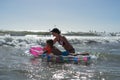 Happy family lifestyle.  Smiling young mother and son jumping and splashing with fun in breaking waves Royalty Free Stock Photo