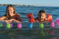 Happy family lifestyle.  Smiling young mother and son jumping and splashing with fun in breaking waves Royalty Free Stock Photo