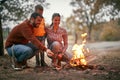 Happy family light fire in wood Royalty Free Stock Photo