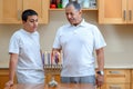 Happy family is lighting a candle celebrating together Jewish holiday Hanukkah. Royalty Free Stock Photo