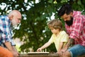 Happy family. Like chess game. I love chess. Healthy lifestyle concept. Cute boy developing chess strategy. Senior man Royalty Free Stock Photo