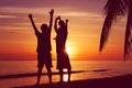 happy family with little child on sunset beach