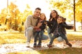 Happy family with little children in sunny park Royalty Free Stock Photo