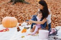 Happy family with little cute child in park on yellow leaf with Royalty Free Stock Photo