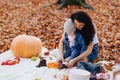 Happy family with little cute child in park on yellow leaf with Royalty Free Stock Photo