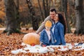 Happy family with little cute child in park on yellow leaf with Royalty Free Stock Photo