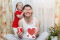 Happy family, little daughter hugs dad and covers his eyes with his palms. Father`s day