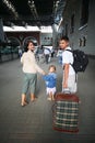 Happy family with little girl at railway station